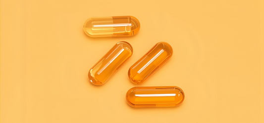 Vitamin D capsules on yellow background