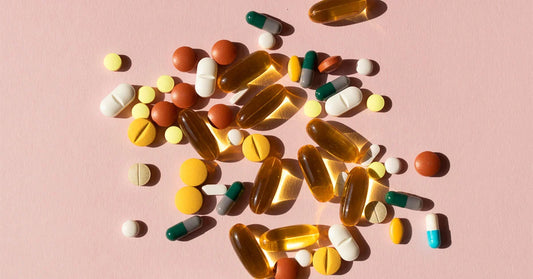 colorful pills with pink background